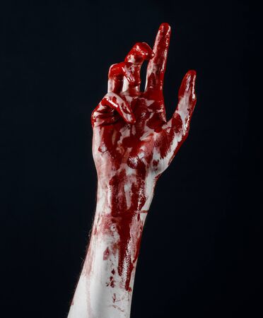 Bloody halloween theme: bloody hands killer zombie isolated on black background in studioの写真素材