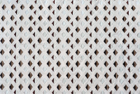 The texture of the fabric in the form of a brown diamond pattern is repeated on the white background...