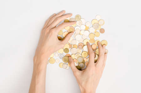 Money and Finance Topic: Money coins and human hand showing gesture on a gray background in studio top view studioの写真素材