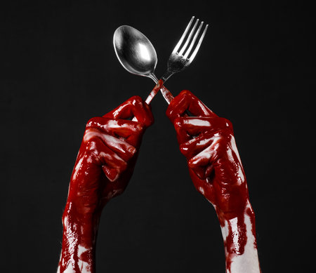 bloody hand holding a spoon, fork, halloween theme, bloody spoon, fork, black background, isolated...