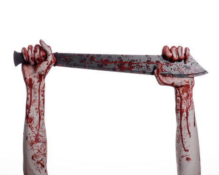 Halloween theme: hand holding a bloody machete on a white background