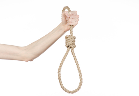 Lynching theme: man's hand holding a loop of rope for hanging on white isolated backgroundの写真素材