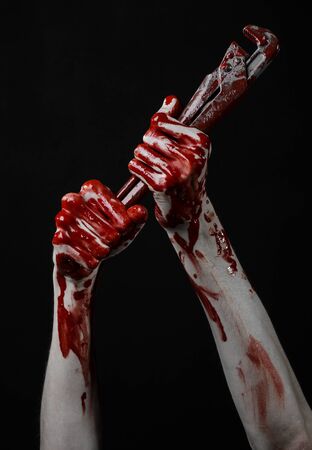 bloody hand holding an adjustable wrench, bloody key, crazy plumber, bloody theme, halloween theme, black background,isolated , bloody hand of an assassin, bloody murderer, psycho, bloody monkey wrenchの写真素材