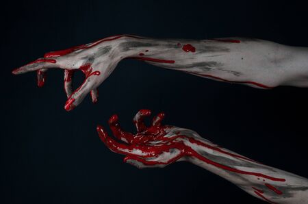 Bloody Halloween theme: horrible zombie demon bloody hands on a black backgroundの写真素材