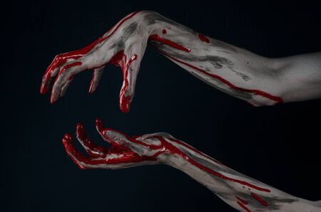Bloody Halloween theme: horrible zombie demon bloody hands on a black backgroundの写真素材