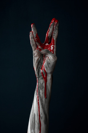 Bloody Halloween theme: horrible zombie demon bloody hands on a black backgroundの写真素材