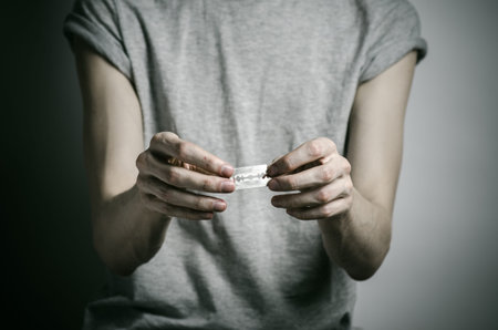 Depressed man holding a razor