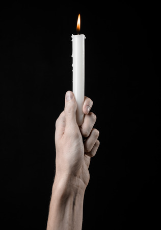 hands holding a candle, a candle is lit, black background, solitude, warmth, in the dark, Hands death, hands witchの写真素材