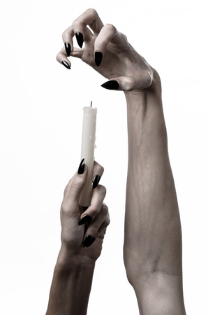 hands holding a candle, a candle is lit, white background, solitude, warmth, in the dark, Hands death, hands witchの写真素材