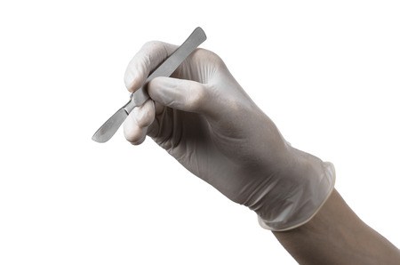 Scalpel in hand in glove on white background, isolated studioの写真素材