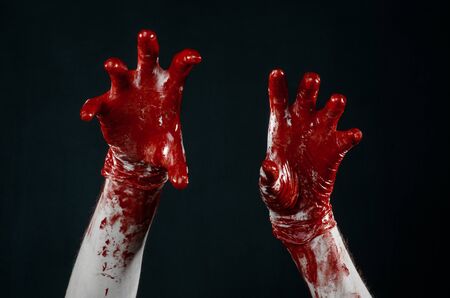 Bloody hands in white gloves, a scalpel, a nail, black background, zombie, demon, maniacの写真素材