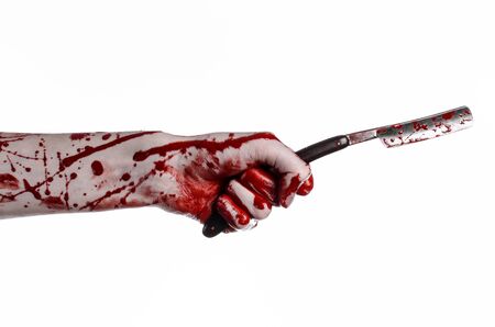 Bloody Halloween theme: bloody hand holds a razor sharp old with a dangerous edge isolated on white backgroundの写真素材