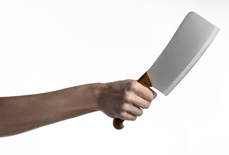 Hand holding a knife for meat, cleaver, chef holding a knife, a large knife, kitchen knife, kitchen theme, white background, isolated, butcher knifeの写真素材