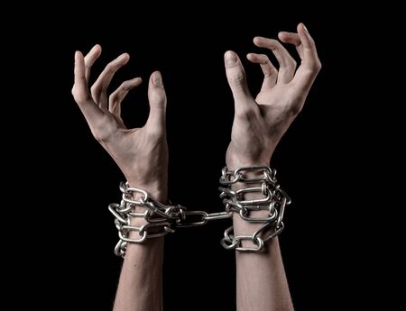 Hands tied chain, kidnapping, dependence, loneliness, social problem, halloween theme, killer, crazy, freedom black backgroundの写真素材