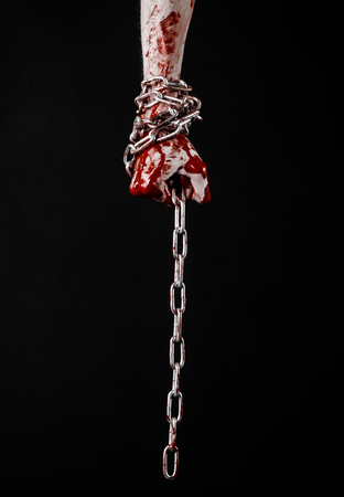 bloody hand holding chain, bloody chain, halloween theme, black background, isolated, killer, fan, crazyの写真素材