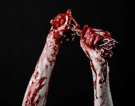 bloody hand holding chain, bloody chain, halloween theme, black background, isolated, killer, fan, crazyの写真素材