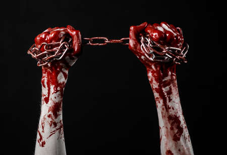 bloody hand holding chain, bloody chain, halloween theme, black background, isolated, killer, fan, crazyの写真素材