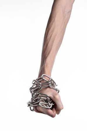 Social theme: hands tied a metal chain on a white backgroundの写真素材
