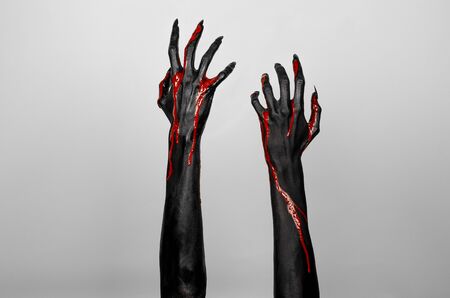 Bloody black hands of death in studioの写真素材