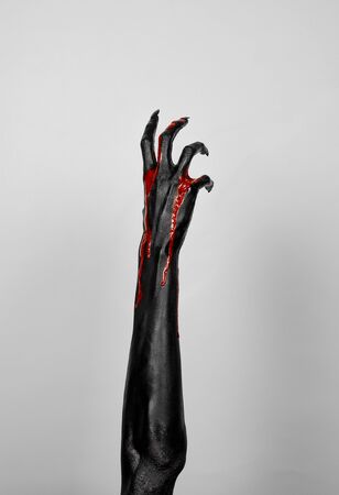 Bloody black hands of death in studioの写真素材