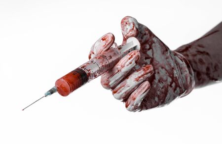 Bloody hand holding a syringe, bloody hands of the doctor, bloody syringe, large syringe, doctor killer, mad doctor, bloody gloves, bloody theme, white background, isolatedの写真素材