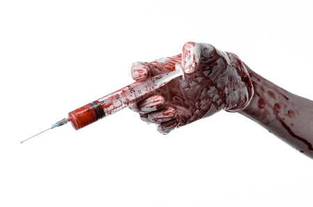 Bloody hand holding a syringe, bloody hands of the doctor, bloody syringe, large syringe, doctor killer, mad doctor, bloody gloves, bloody theme, white background, isolatedの写真素材
