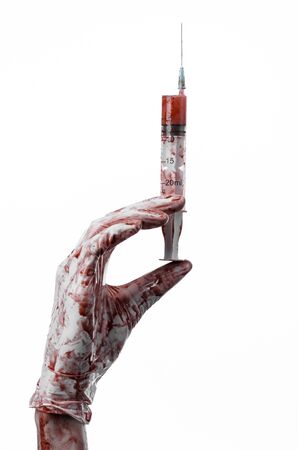 Bloody hand holding a syringe, bloody hands of the doctor, bloody syringe, large syringe, doctor killer, mad doctor, bloody gloves, bloody theme, white background, isolatedの写真素材