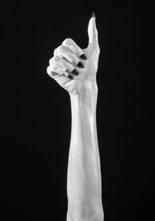 white hands of death with black nails, white death, the devil's hands, the hands of a demon, white skin, halloween theme, black background, isolated studioの写真素材
