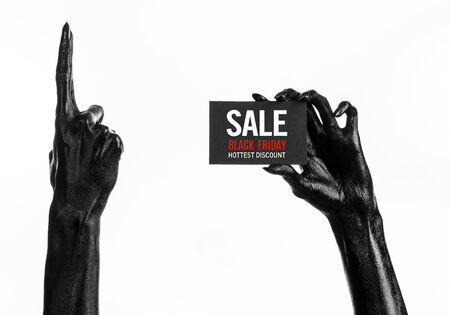 Black Friday theme: black hand holding a card with discount on white background studioの写真素材