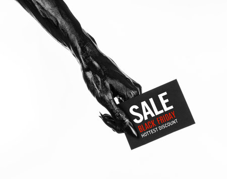 Black Friday theme: black hand holding a card with discount on white background studio