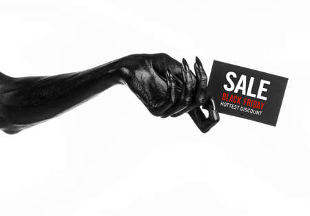 Black Friday theme: black hand holding a card with discount on white background studioの写真素材