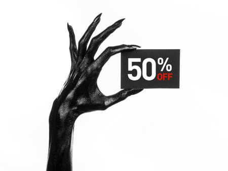 Hot sale topic: black hand holding a card with a 50% discount on white background studioの写真素材