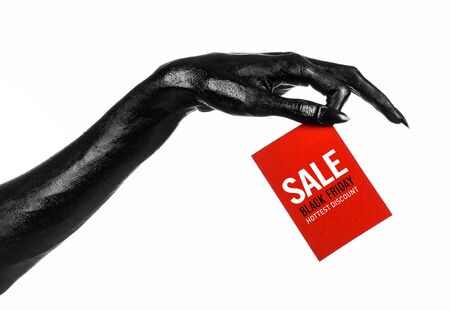 Black Friday theme: black hand holding a red card for a discount on white background studioの写真素材