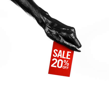 Hot sale topic: black hand holding a red card with 20 % discount on white background studioの写真素材