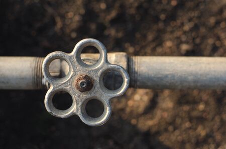 Iron rusty tap valve in the garden with a pipe studioの写真素材