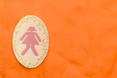 A lady toilet sign on orange backgroundの写真素材