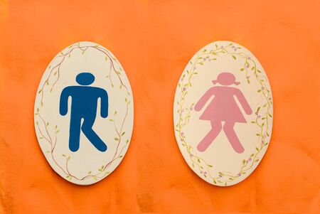 A man and lady toilet sign on orange backgroundの写真素材