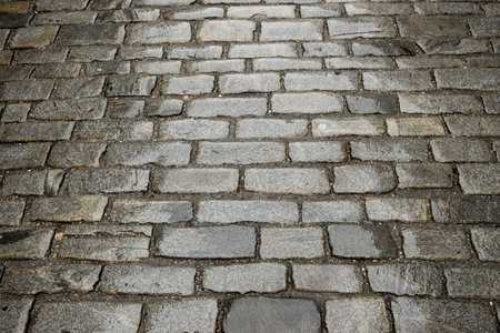 textured background of ancient street paved with cobblestone