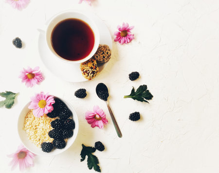 oatmeal for Breakfast with BlackBerry and flowers on white background