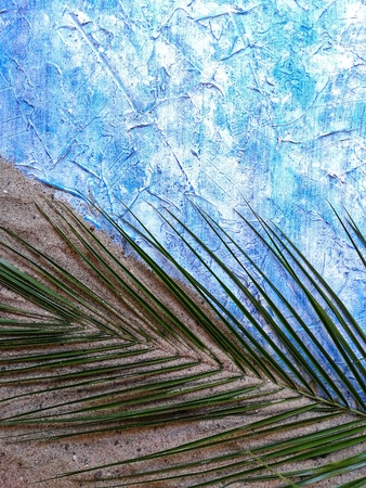 pineapple , grapefruit and bananas with a green branch of palm trees on the sand with the phoneの写真素材