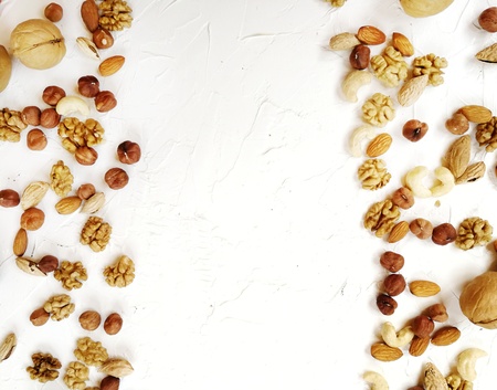 different nuts, peeled and in-shell on textured backgroundの写真素材