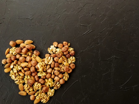 different nuts, peeled and in-shell on textured backgroundの写真素材