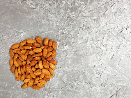 walnut almonds peeled and in-shell on a gray backgroundの写真素材