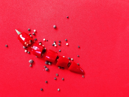 red hot pepper on a red uniform backgroundの写真素材