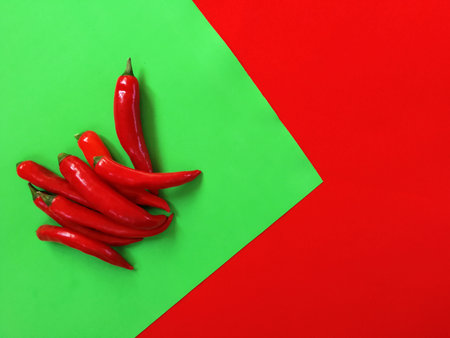 red hot pepper on a uniform green background