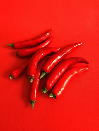 red hot pepper on red plain background