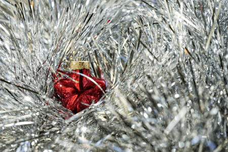 New Year's ball on a background of white tinsel.の写真素材