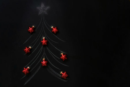 Christmas tree drawn on a chalkboard.Decorated with a garland design with glowing lights, Concept of...