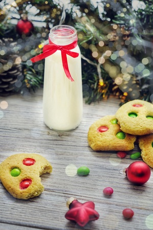 Shortbread cookies with multi colored candy and chocolate chips, served with glass of milk, square format.の写真素材