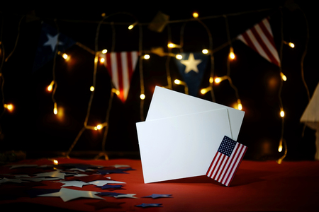 Fireworks display celebrates the independence Day of the United States of America nation on the fourth of July with the us flag , sparklers , candy, on the red background and on the background of Christmas garland and bokeh, with the stars , the end of the Celebration of freedom.の写真素材